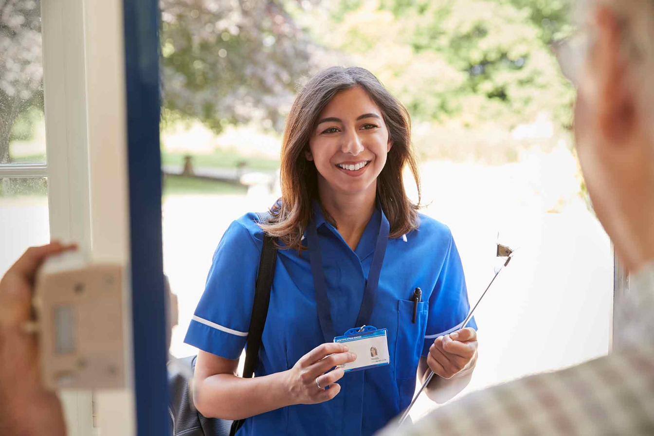 A nurse arriving for a home visit, ID badge visible